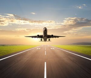 airplane landing at airport during dusk hour